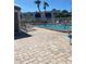 Community pool area with lounge chairs, lush landscaping, and a glimpse of the condos at 7701 Starkey Rd # 602, Seminole, FL 33777
