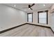 Bright bedroom featuring new flooring, ceiling fan, recessed lights, and dark window trim at 9208 N 27Th St, Tampa, FL 33612
