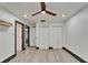 Bright bedroom with ceiling fan, closet space, and hardwood floors at 9208 N 27Th St, Tampa, FL 33612