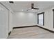 Bright bedroom featuring new flooring, ceiling fan, recessed lights, and white trim and doors at 9208 N 27Th St, Tampa, FL 33612