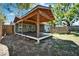 This backyard includes a spacious covered wooden deck, partially fenced, ideal for outdoor activities at 9208 N 27Th St, Tampa, FL 33612