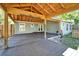 The home has a covered dark wood deck, with a partial fence, perfect for outdoor entertaining at 9208 N 27Th St, Tampa, FL 33612