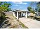 The exterior of this property has a light green paint, a covered car port and partial fencing at 9208 N 27Th St, Tampa, FL 33612