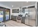 Modern kitchen with stainless steel appliances, granite countertops, and dark cabinets at 9208 N 27Th St, Tampa, FL 33612