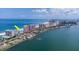 Expansive aerial perspective featuring the condo and the complex, white sandy beach, and city skyline in the distance at 1350 Gulf Blvd # 301, Clearwater Beach, FL 33767