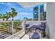 Balcony has seating and scenic views of palm trees and nearby buildings at 1350 Gulf Blvd # 301, Clearwater Beach, FL 33767