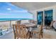 A waterfront balcony with a table and chairs has an ocean view and beach access at 1350 Gulf Blvd # 301, Clearwater Beach, FL 33767