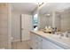 Bright bathroom featuring double sinks, a spacious vanity, and access to a shower and bedroom at 1350 Gulf Blvd # 301, Clearwater Beach, FL 33767