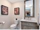 Stylish powder room featuring modern fixtures, a vanity with marble countertop, and decorative artwork at 1350 Gulf Blvd # 301, Clearwater Beach, FL 33767
