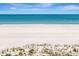 Scenic beach and calm blue ocean on a clear sunny day with lush sea grass at 1350 Gulf Blvd # 301, Clearwater Beach, FL 33767