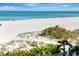 Serene beach view with soft white sand and calm turquoise waters, inviting relaxation and leisurely seaside enjoyment at 1350 Gulf Blvd # 301, Clearwater Beach, FL 33767