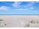 Expansive beach view showcasing wide sandy beach and ocean vistas under a bright blue sky with scattered clouds at 1350 Gulf Blvd # 301, Clearwater Beach, FL 33767