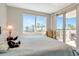 Light-filled bedroom with a comfortable bed, a window view to palm trees, and a balcony entrance at 1350 Gulf Blvd # 301, Clearwater Beach, FL 33767