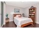 Bright bedroom features wood floors, a white comforter, and a wood bookshelf at 1350 Gulf Blvd # 301, Clearwater Beach, FL 33767