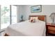 Comfortable bedroom with view to outdoor balcony through sliding glass doors, creating a relaxing ambiance at 1350 Gulf Blvd # 301, Clearwater Beach, FL 33767