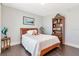 Cozy bedroom with wood floors, a comfortable bed, and a bookshelf for storage and display at 1350 Gulf Blvd # 301, Clearwater Beach, FL 33767