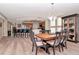 Light-filled dining area with wood-look floors, stylish lighting and seating for six at 1350 Gulf Blvd # 301, Clearwater Beach, FL 33767