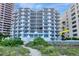Beachfront condo with multiple balconies offering panoramic ocean views and lush landscaping at 1350 Gulf Blvd # 301, Clearwater Beach, FL 33767