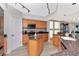 Kitchen features an island, stainless steel appliances and wood cabinets at 1350 Gulf Blvd # 301, Clearwater Beach, FL 33767