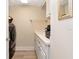 Convenient laundry room featuring modern appliances, storage cabinets, and a built-in sink at 1350 Gulf Blvd # 301, Clearwater Beach, FL 33767