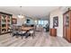 Open-concept living room with dining area and a view of the ocean through sliding glass doors at 1350 Gulf Blvd # 301, Clearwater Beach, FL 33767