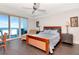 Main bedroom with a water view, ceiling fan and sliding glass doors to a patio at 1350 Gulf Blvd # 301, Clearwater Beach, FL 33767