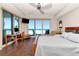 Waterfront main bedroom with ceiling fan, desk area and large sliding glass doors to a patio at 1350 Gulf Blvd # 301, Clearwater Beach, FL 33767