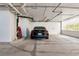 Well-lit garage parking spot with black car at 1350 Gulf Blvd # 301, Clearwater Beach, FL 33767