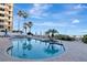Sparkling community pool with beach views and ample lounge seating at 1350 Gulf Blvd # 301, Clearwater Beach, FL 33767