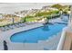 Aerial view of a waterfront community pool with plenty of loungers and beach access at 1350 Gulf Blvd # 301, Clearwater Beach, FL 33767