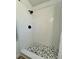 Clean, newly tiled shower with black fixtures and patterned floor at 10408 N 50Th St # 1/2, Tampa, FL 33617
