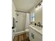 Stylish bathroom with modern fixtures, tiled walk-in shower, and sleek vanity with under-sink storage at 10408 N 50Th St # 1/2, Tampa, FL 33617