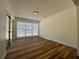 Sun-filled bedroom with wood flooring, sliding glass doors, and ample natural light at 10408 N 50Th St # 1/2, Tampa, FL 33617