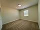 Carpeted bedroom with neutral paint and natural light from a window at 10408 N 50Th St # 1/2, Tampa, FL 33617