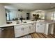 Modern kitchen with stainless steel appliances, white countertops, and an open view to living area at 10408 N 50Th St # 1/2, Tampa, FL 33617