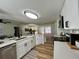 Modern kitchen with stainless steel appliances, white countertops, and an open view to living area at 10408 N 50Th St # 1/2, Tampa, FL 33617