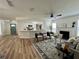 Bright living room featuring a fireplace, modern furniture, and an open view of the kitchen at 10408 N 50Th St # 1/2, Tampa, FL 33617