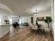 Open-concept living space featuring dining area, fireplace, wood flooring, and natural light at 10408 N 50Th St # 1/2, Tampa, FL 33617
