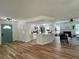 Open concept living space with wood floors, updated kitchen, fireplace, and modern decor at 10408 N 50Th St # 1/2, Tampa, FL 33617