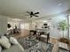 Bright living room with dining area and an open view of the kitchen and ceiling fan at 10408 N 50Th St # 1/2, Tampa, FL 33617