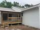 A well maintained home with a wooden porch and steps nestled into a treed lot at 10408 N 50Th St # 1/2, Tampa, FL 33617