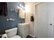 Stylish bathroom features a modern vanity, mirror, and shelving against blue accent wall at 109 W Saint Lucia Loop, Apollo Beach, FL 33572