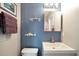 Charming bathroom features sleek vanity, mirror, and coastal-themed decor against blue wall at 109 W Saint Lucia Loop, Apollo Beach, FL 33572