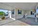 Carport view with white siding, blue shutters and stairs leading up to front door at 109 W Saint Lucia Loop, Apollo Beach, FL 33572