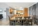 Cozy dining area with modern table, chairs, and modern lighting with an adjacent kitchen at 109 W Saint Lucia Loop, Apollo Beach, FL 33572
