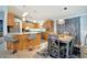 Cozy dining area with modern table, chairs, and modern lighting with an adjacent kitchen at 109 W Saint Lucia Loop, Apollo Beach, FL 33572