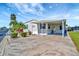 Charming single-story home with a carport, landscaped yard, and mature palm trees at 109 W Saint Lucia Loop, Apollo Beach, FL 33572