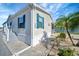Charming home featuring blue shutters, tropical landscaping and a welcoming entrance at 109 W Saint Lucia Loop, Apollo Beach, FL 33572