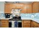Stylish kitchen showcasing stainless steel appliances, tiled backsplash, wood cabinets, and light countertops at 109 W Saint Lucia Loop, Apollo Beach, FL 33572