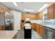 Bright kitchen featuring updated appliances, wood cabinetry, and breakfast bar at 109 W Saint Lucia Loop, Apollo Beach, FL 33572